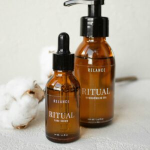 Minimalist product shot of Ritual face serum and hydrophilic oil with cotton for skincare.